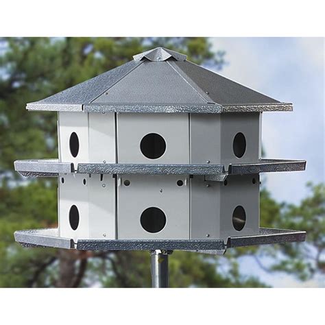 large bird houses on poles